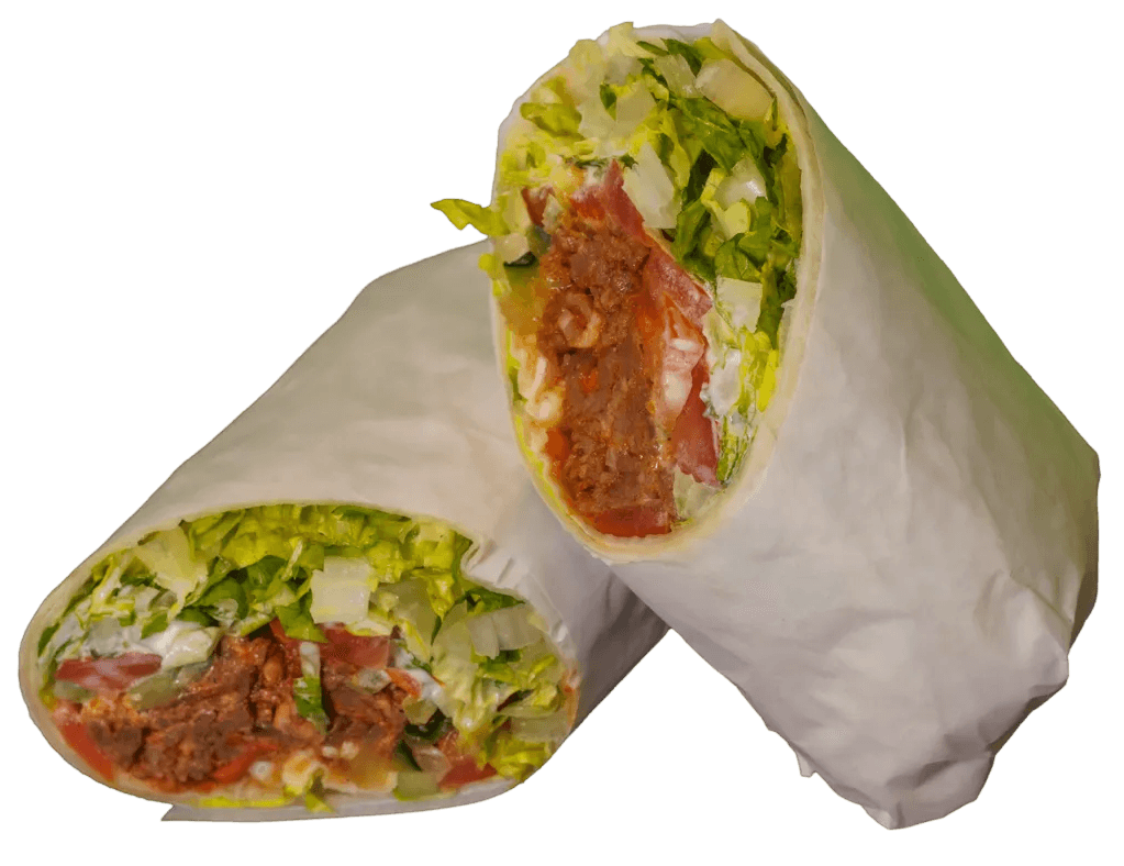 A bulgogi wrap cut in half, revealing a vibrant filling of crisp lettuce, diced tomatoes, and seasoned meat, partially wrapped in white paper.